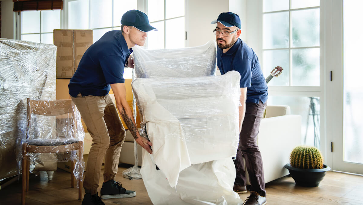 movers carrying wrapped furniture